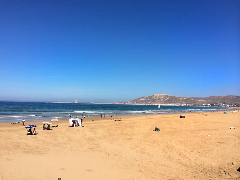 Long sandy beach curving around Agadir bay under a clear sky