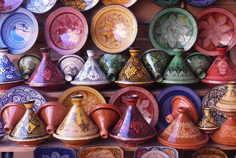Painted ceramic tajines stacked in a pottery shop
